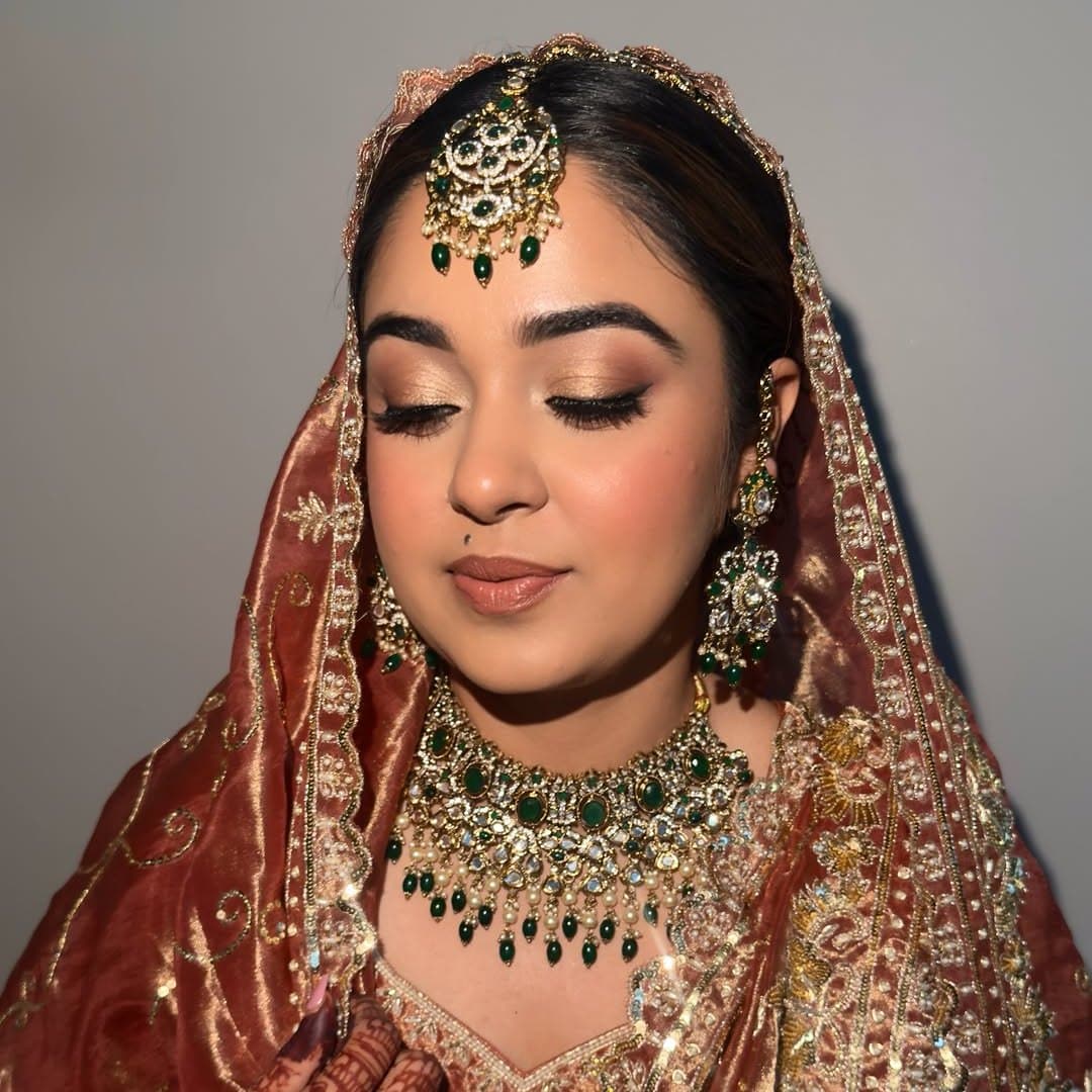 Bridal makeup close-up in maroon and gold