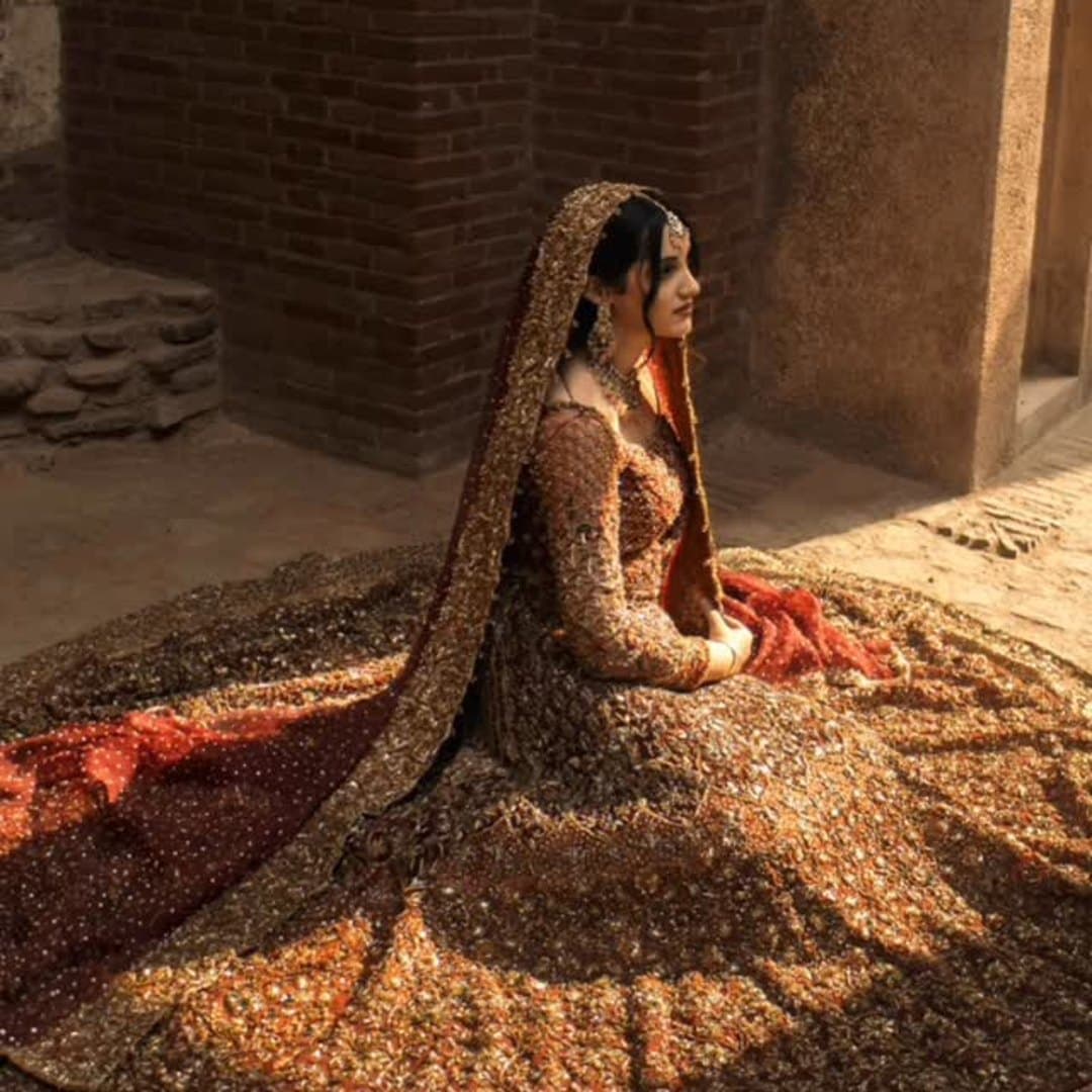 Bride in a maroon and gold lehenga — editorial portrait