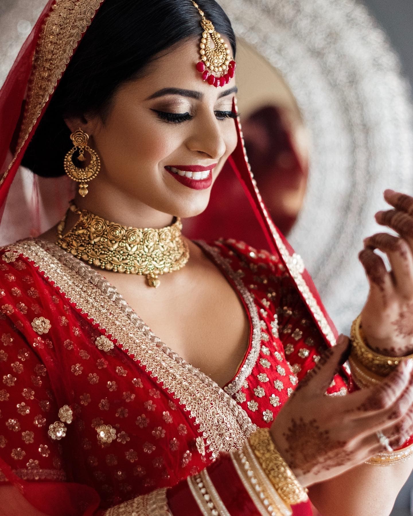 Traditional red bridal look with modern full glam makeup